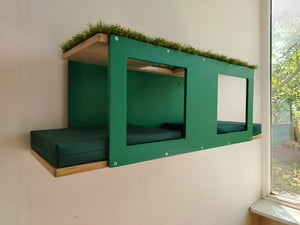 Outdoor cat enclosure shelf, wall mounted multilevel tunnel. It's with emerald green accent and birch base, with pillows in tenda green and artificial carpet on top.