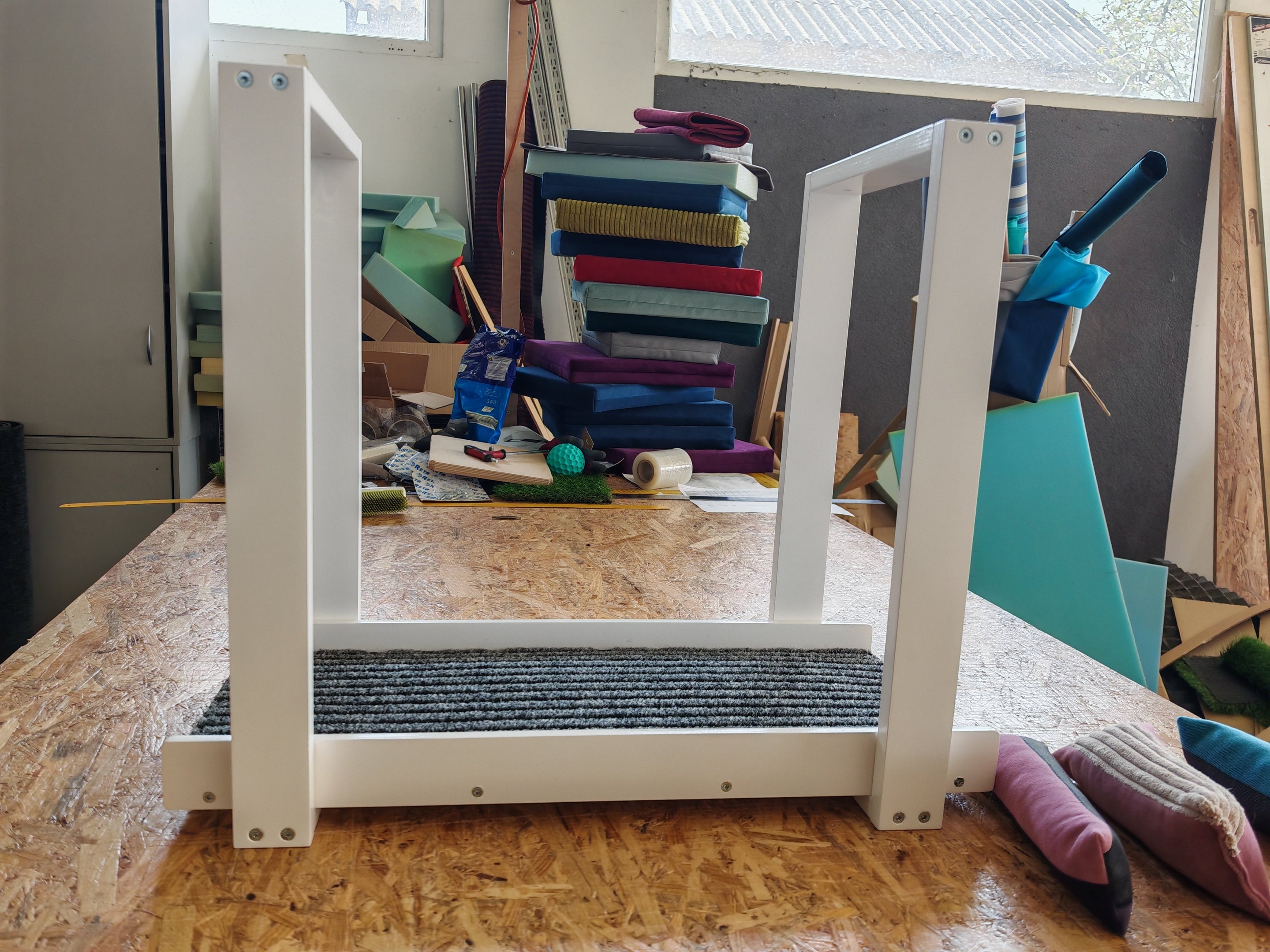 Small ceiling mounted walkway in white. Carpeted for extra grip