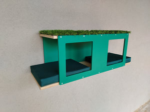 Wall mounted cat tunnel shelf for large cats. Ideal for outdoor use. The tunnel is multilevel, the bottom shelf has 2 large comfortable custions in tenda green color, the top level has a hole in the middle as an entrance and is carpeted with artificial grass. The base is birch natural and the accent is emerald green. It's easy to mount and comes with hardware.